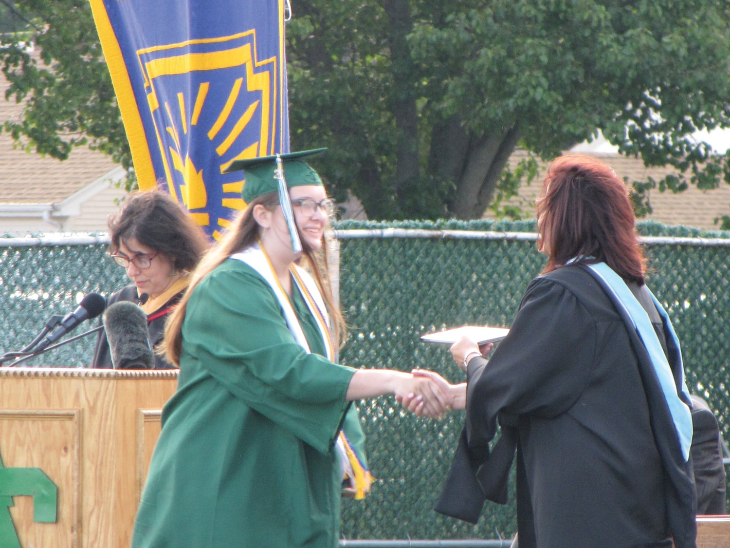 CROSSING THE STAGE: Class of 2021 graduate Avery Hart receives her diploma from Superintendent Jeannine Nota-Masse.